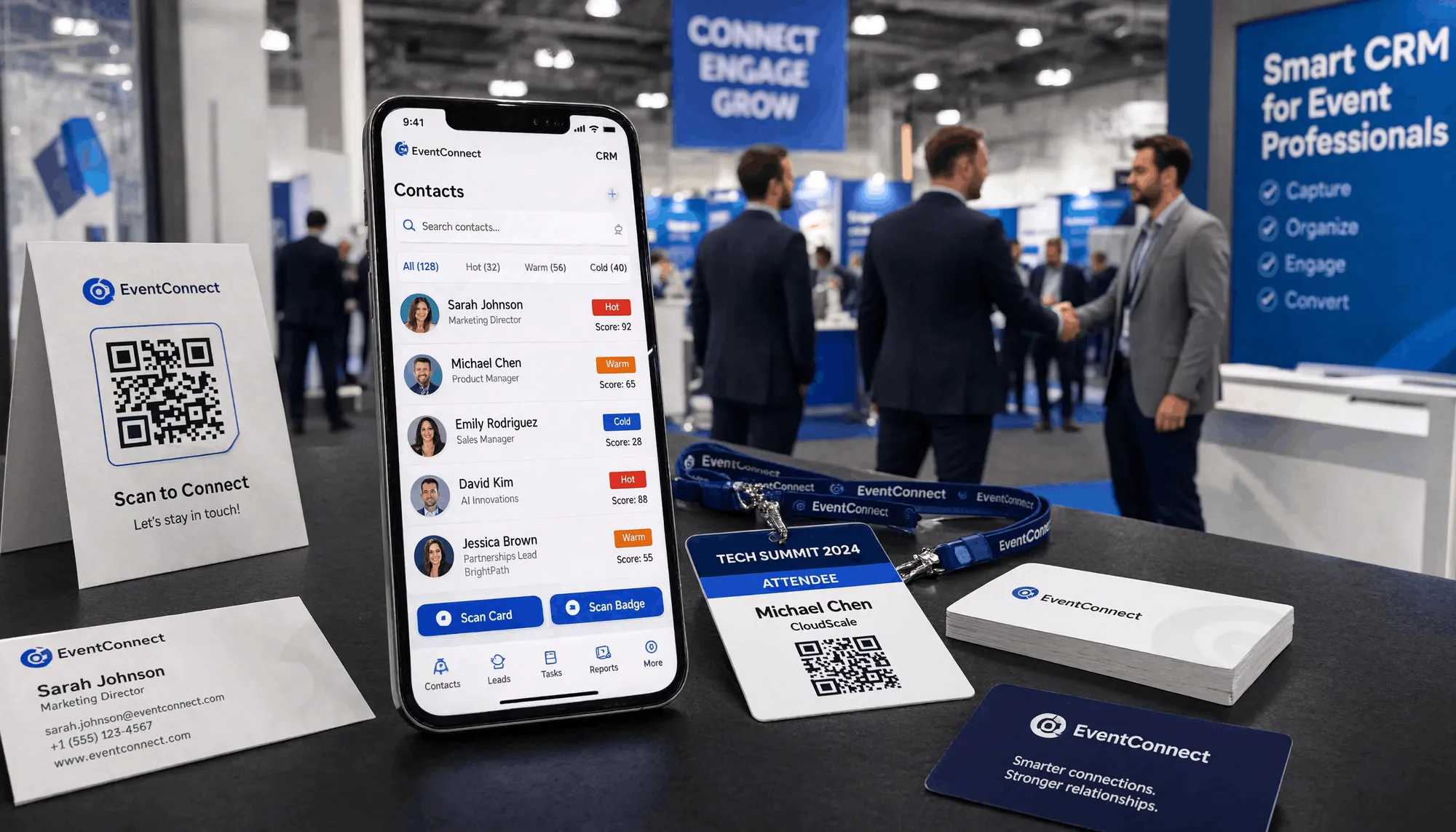 A modern smartphone on a trade show booth table displaying an offline CRM app with contact cards and Hot/Warm/Cold lead scores, surrounded by business cards and badges, with a blurred convention hall and networking crowd in the background.